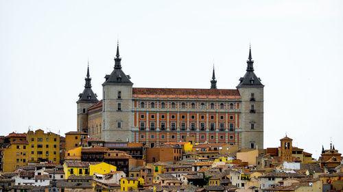 View of buildings in city against clear sky