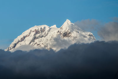 Low angle view of snowcapped mountain against sky