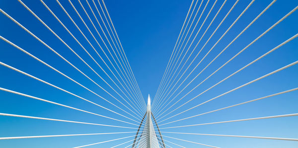 Low angle view of cable-stayed bridge against sky