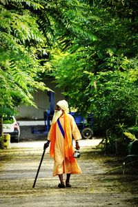 Rear view of man walking on road