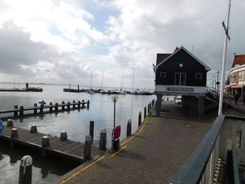 Pier by sea against sky