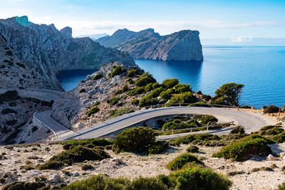 Scenic view of sea and mountains against sky