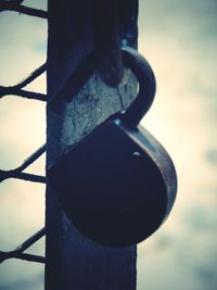 Close-up of rusty metal against sky