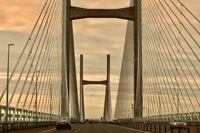 View of suspension bridge against sky during sunset