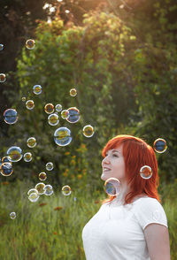 Young woman blowing bubbles