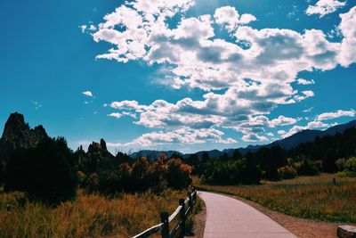 Road amidst trees against sky