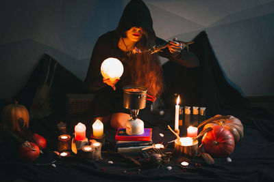 Close up magician with glowing ball eating portrait picture