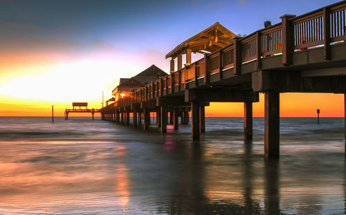 Scenic view of sea against romantic sky at sunset