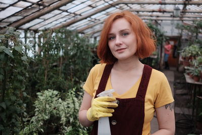 Young ginger gardener in a greenhouse