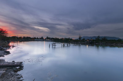Scenic view of lake against sky at sunset