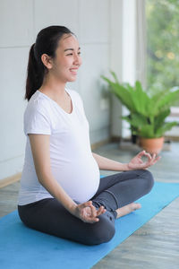 Young woman sitting on floor