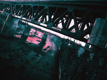 Low angle view of bridge over river at night