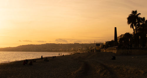 Scenic view of beach against sky during sunset