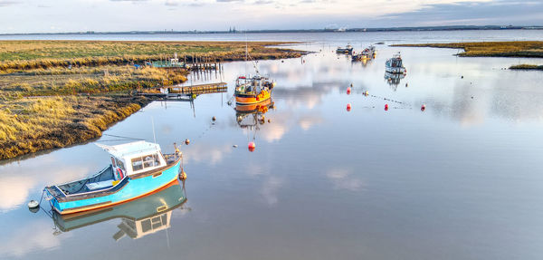 High angle view of boats in lake against sky