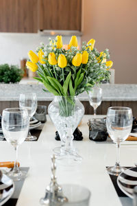 Flowers in glass vase on table