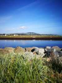 Scenic view of sea against blue sky