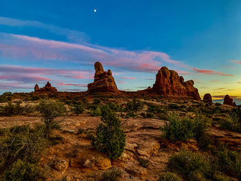 Rock formations on landscape against sky