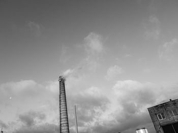 Low angle view of crane against sky