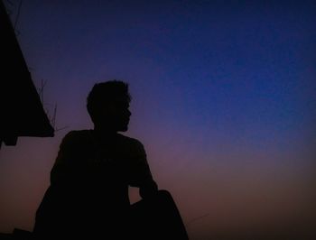 Silhouette of man against sky at night