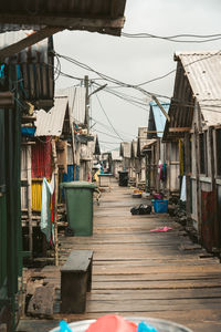 Clothes drying on alley amidst buildings in city