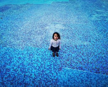 High angle view of woman standing in swimming pool