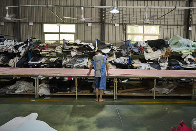 Worker in storage room for different materials used for making shoes at chinese shoes factory
