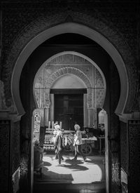 Rear view of people at entrance of building