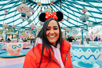 Portrait of smiling young woman in amusement park