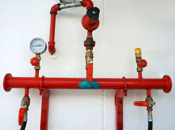 Close-up of red pipe against wall