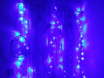 Low angle view of illuminated lights at night