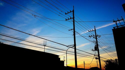 Low angle view of electricity pylon against sky