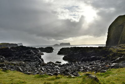 Rocks on beach against sky