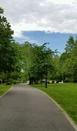 Road amidst trees against sky