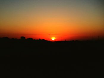 Scenic view of silhouette landscape against romantic sky at sunset