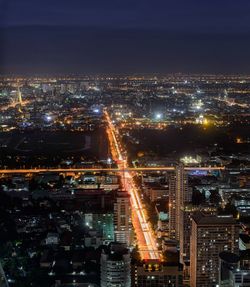 Aerial view of city lit up at night