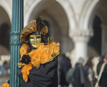 Person in costume while wearing venetian mask at venice carnival