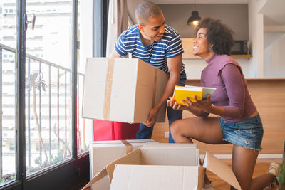 Smiling couple looking at each other in new house