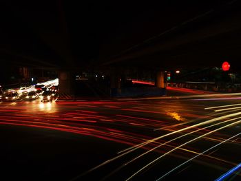 Light trails on road in city at night