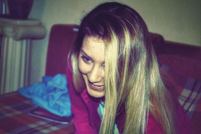 Close-up of young woman sitting at home