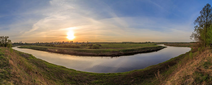 Scenic view of field against sky during sunset