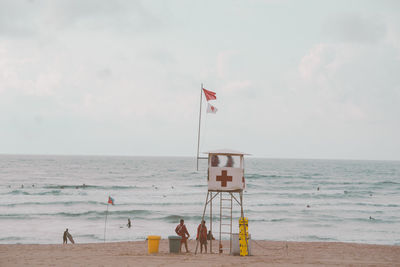 People on beach against sky