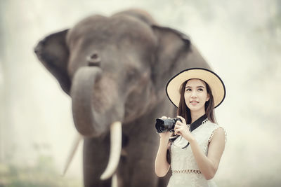 Portrait of young woman photographing