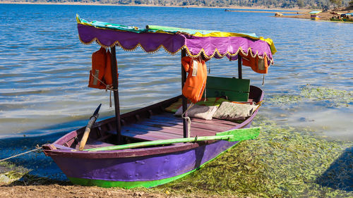 Multi colored boats moored on shore