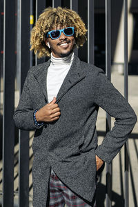 Portrait of young man wearing sunglasses standing outdoors