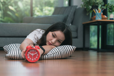 Portrait of young woman lying on table