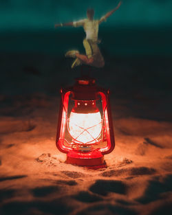 Close-up of illuminated lantern on table