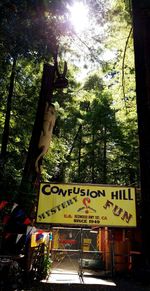 Information sign by trees in forest