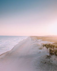 Scenic view of sea against clear sky during sunset