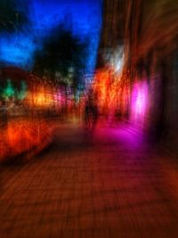 Digital composite image of illuminated footpath in city at night