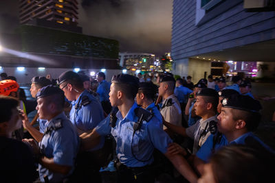 Group of people in front of building at night